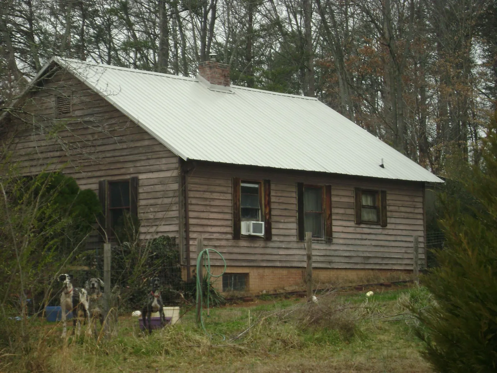 White metal roof on an old wood sided farmhouse, from a Metal Roof Installation job in West Babylon